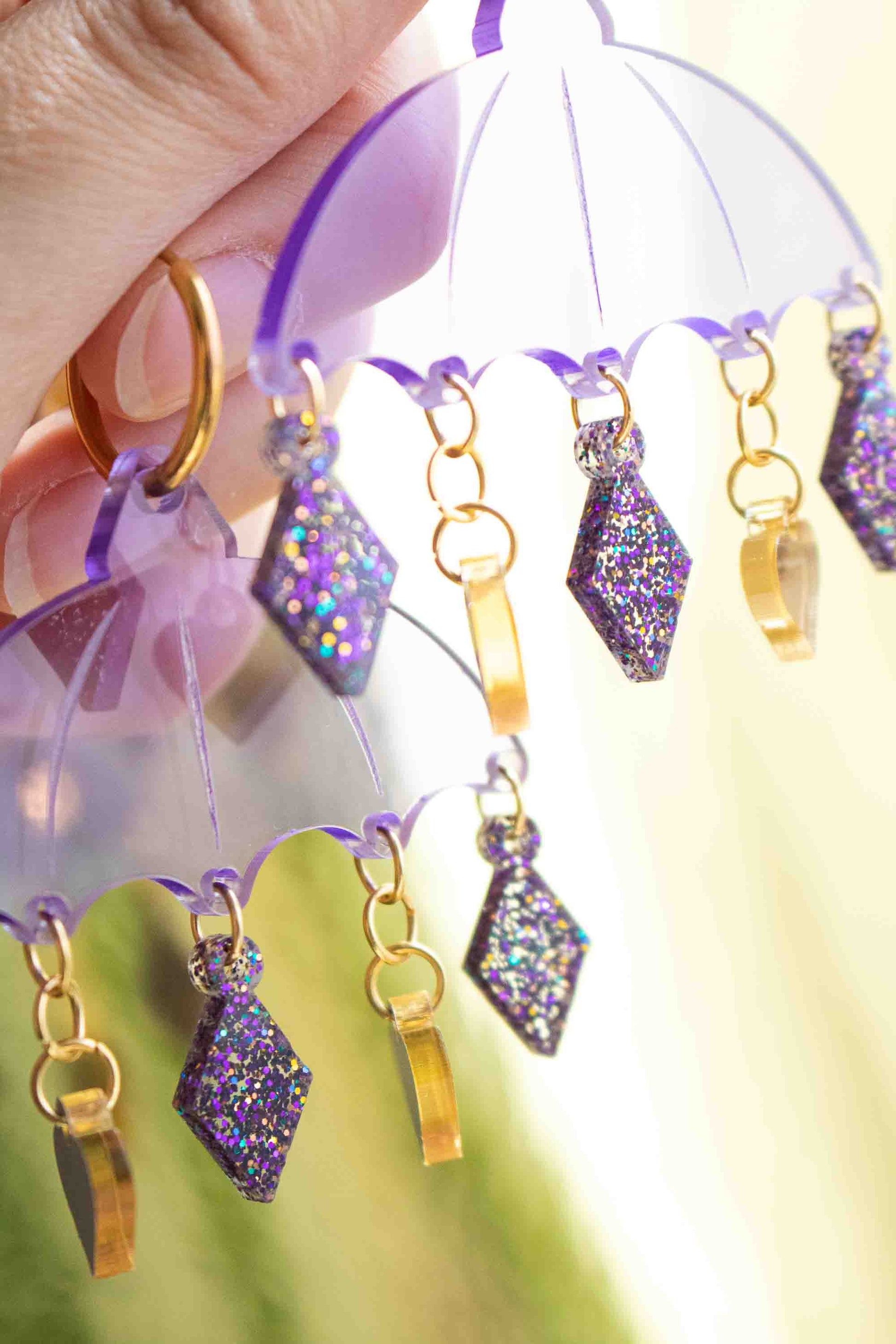 Boucles d'oreilles violettes en acrylique decoupe laser, bijou colore Limonade Studio, suspendues avec charms pendants et anneau dore.